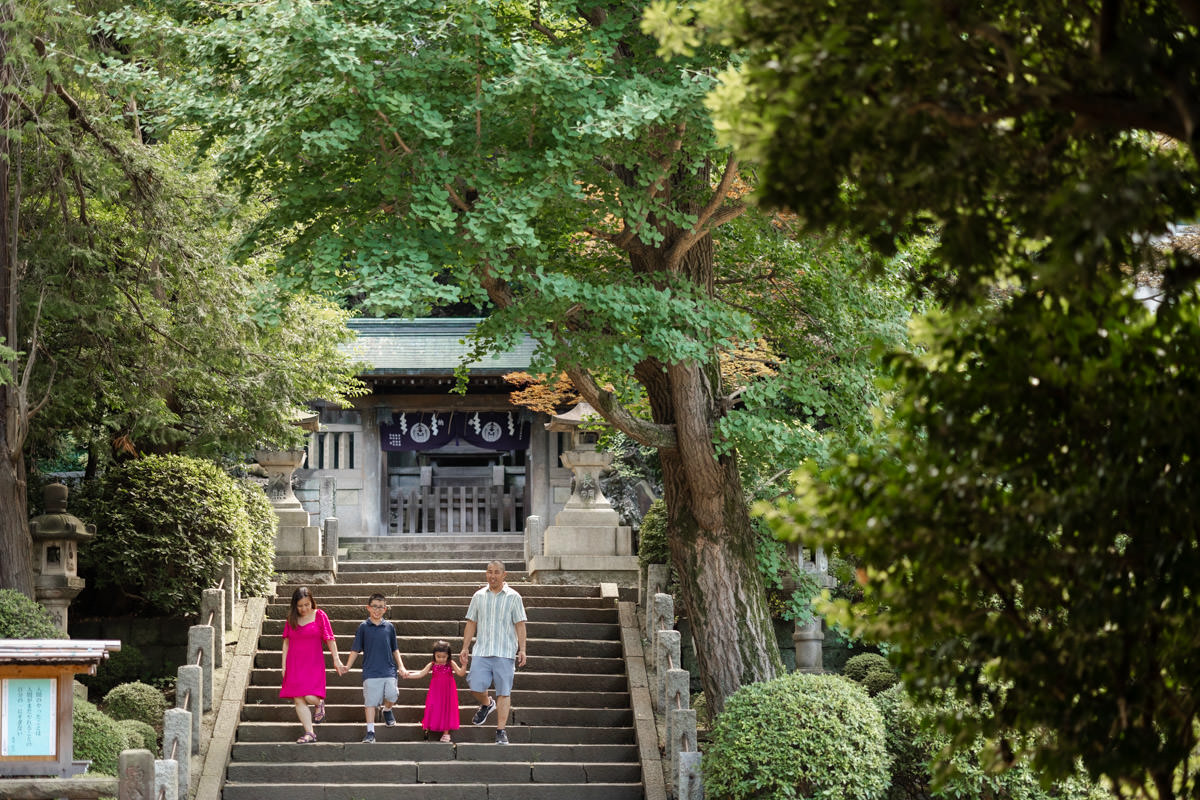 Family walking down the steps of shrine.